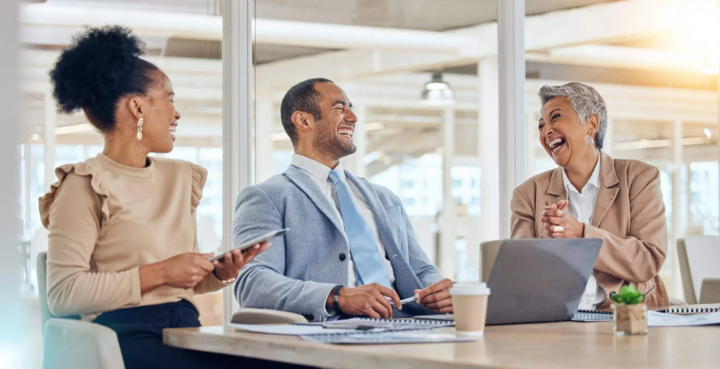 Happy business people, team and laughing in meeting for company update, planning or feedback review. Diversity, corporate group or office employees in collaboration, conversation with a funny joke